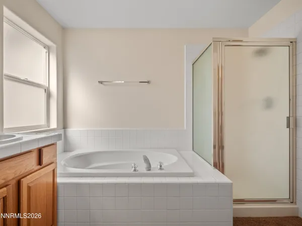 a bathroom with a bathtub and a window
