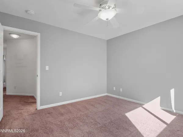 a view of an empty room with a fan