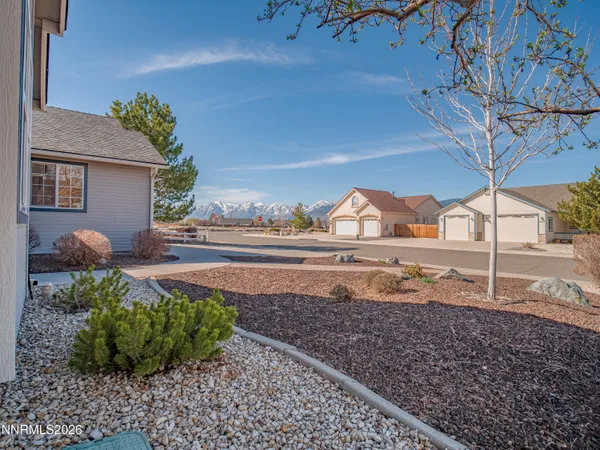 a view of a house with a yard and a garden