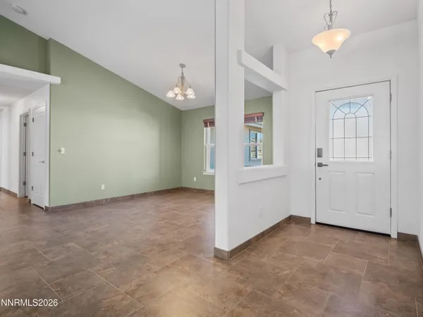 an empty room with windows and entrance