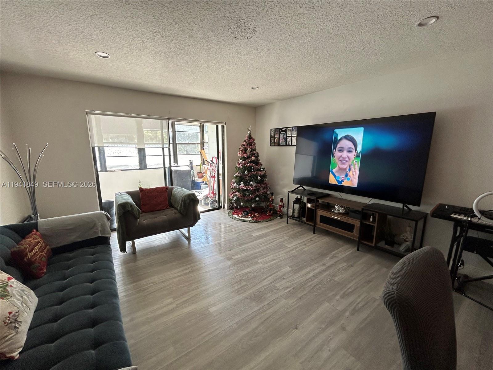 200 Gate Road, Unit 207 Hollywood, FL 33024 - Photo 13 of 38 a living room with furniture and a flat screen tv