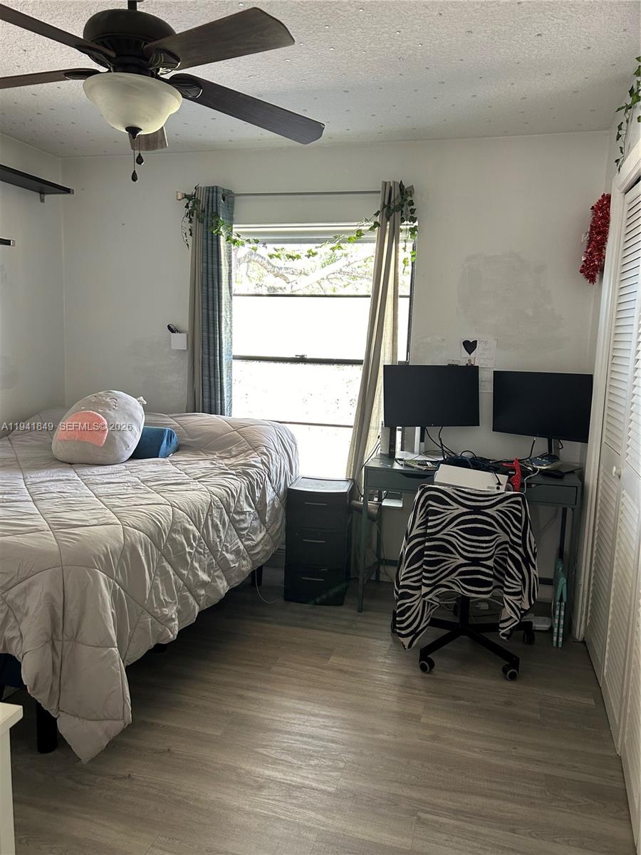 200 Gate Road, Unit 207 Hollywood, FL 33024 - Photo 17 of 38 a bedroom with a bed and a window