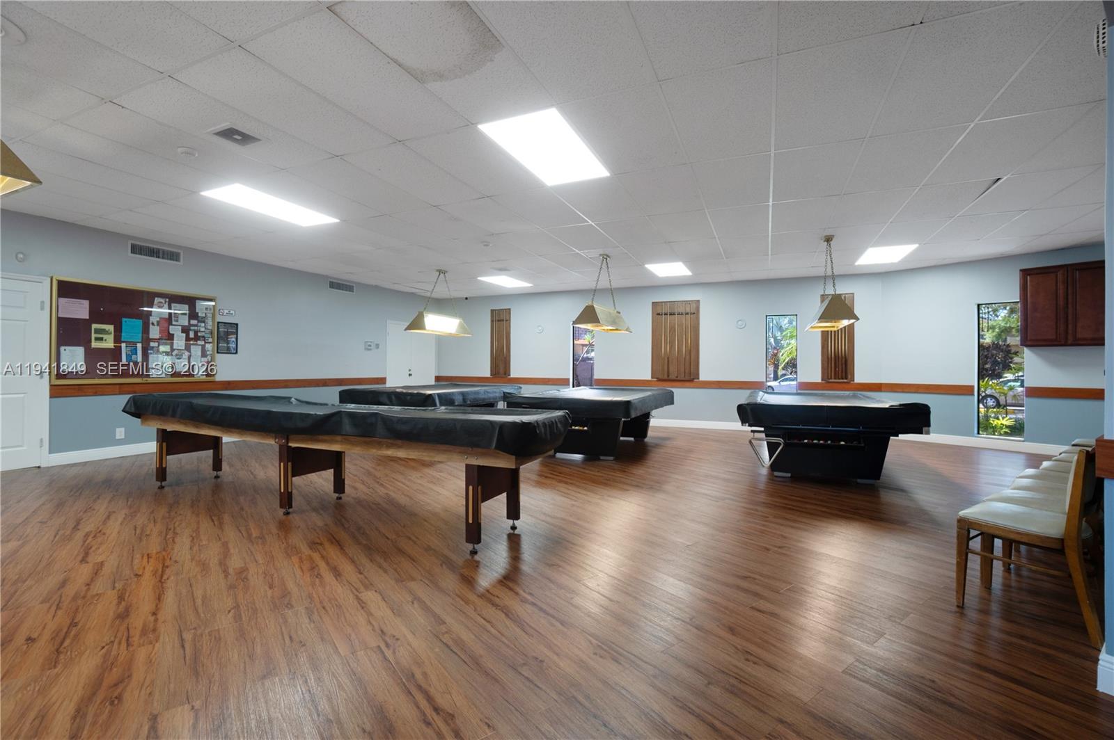 200 Gate Road, Unit 207 Hollywood, FL 33024 - Photo 31 of 38 a living room with furniture a table and a flat screen tv