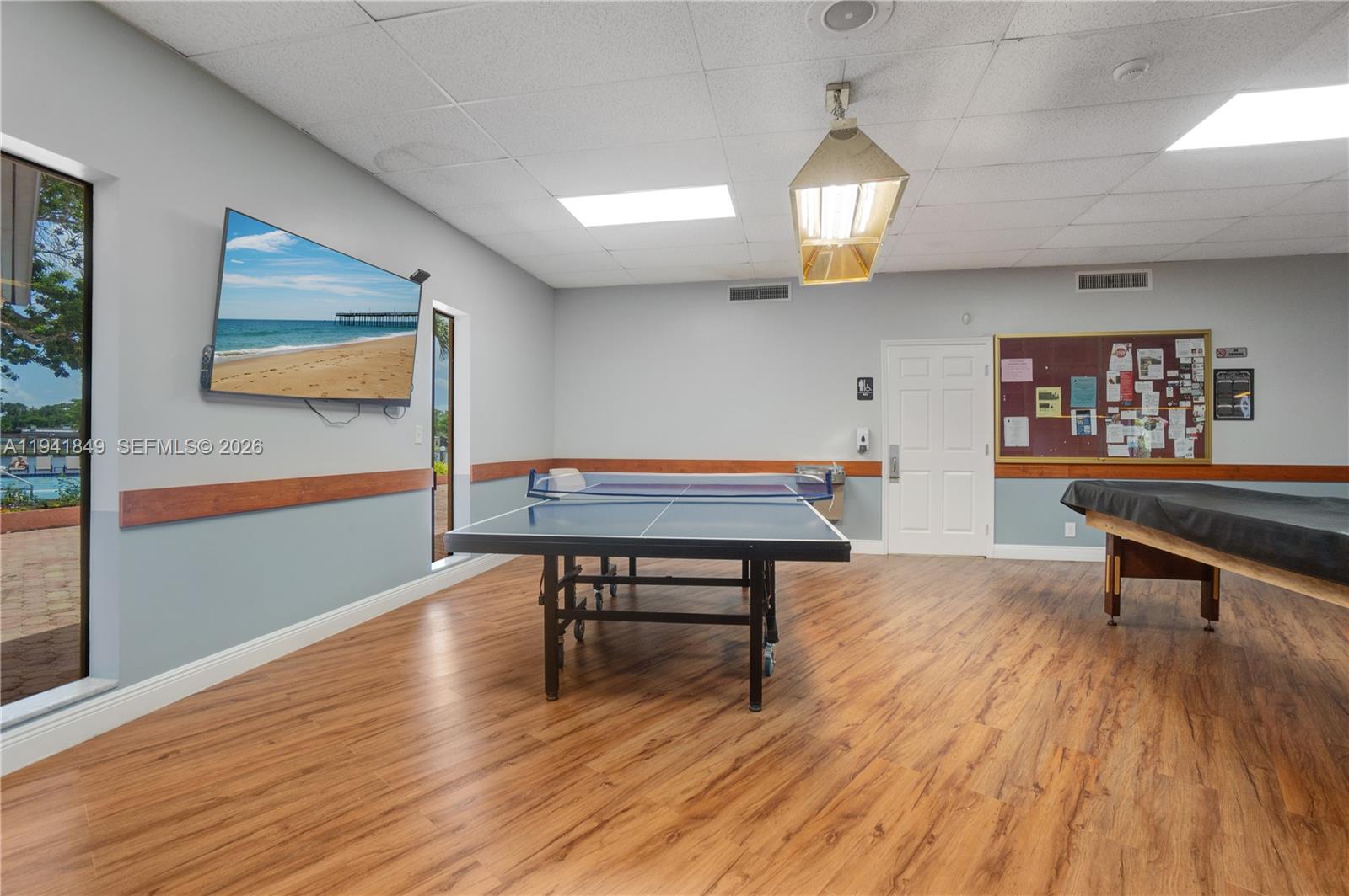 200 Gate Road, Unit 207 Hollywood, FL 33024 - Photo 32 of 38 a living room with furniture a table and wooden floor