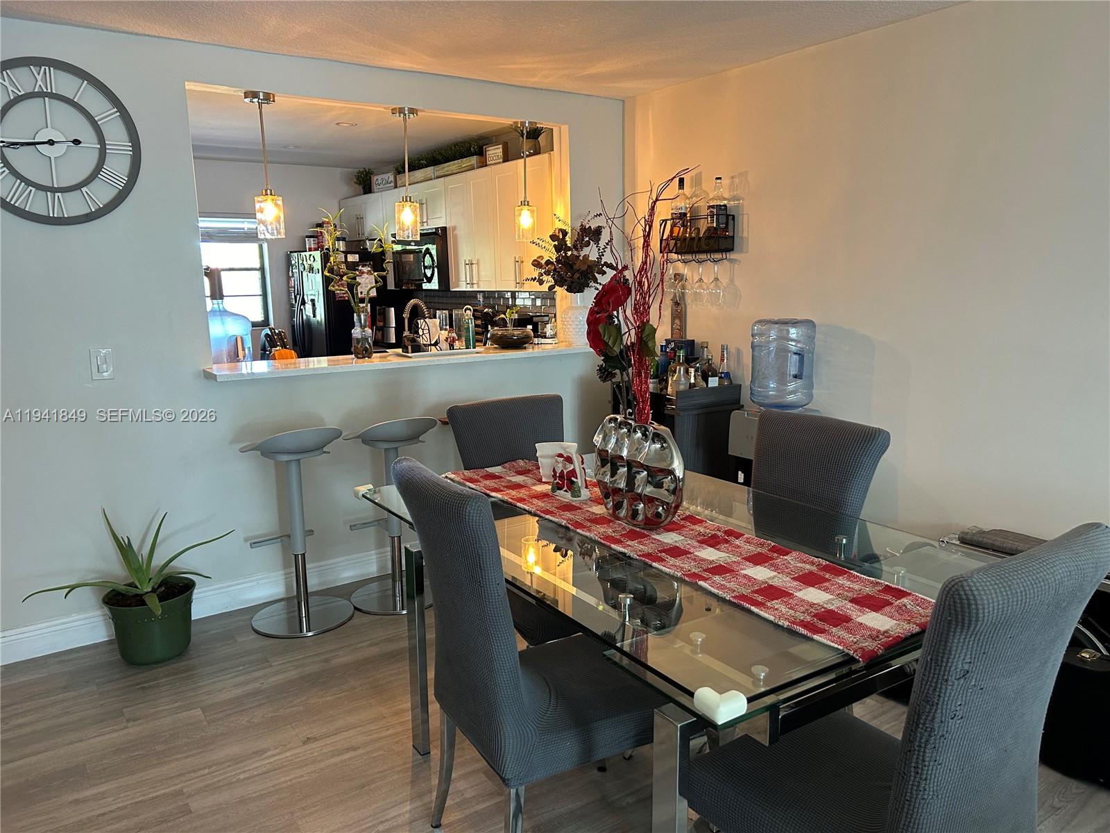 200 Gate Road, Unit 207 Hollywood, FL 33024 - Photo 10 of 38 a view of a dining room with furniture and wooden floor