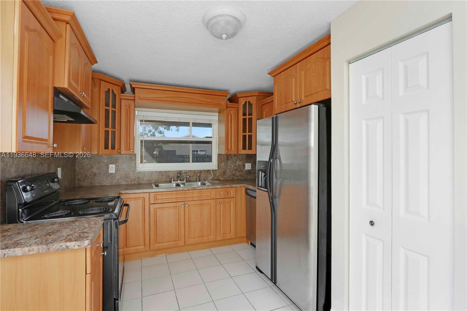 13244 Southwest 255th Terrace Homestead, FL 33032 - Photo 13 of 22 a kitchen with stainless steel appliances granite countertop a refrigerator and a sink