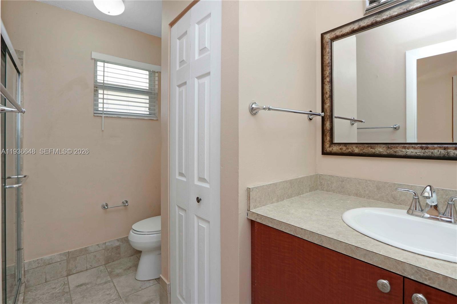 13244 Southwest 255th Terrace Homestead, FL 33032 - Photo 18 of 22 a bathroom with a granite countertop sink toilet and shower