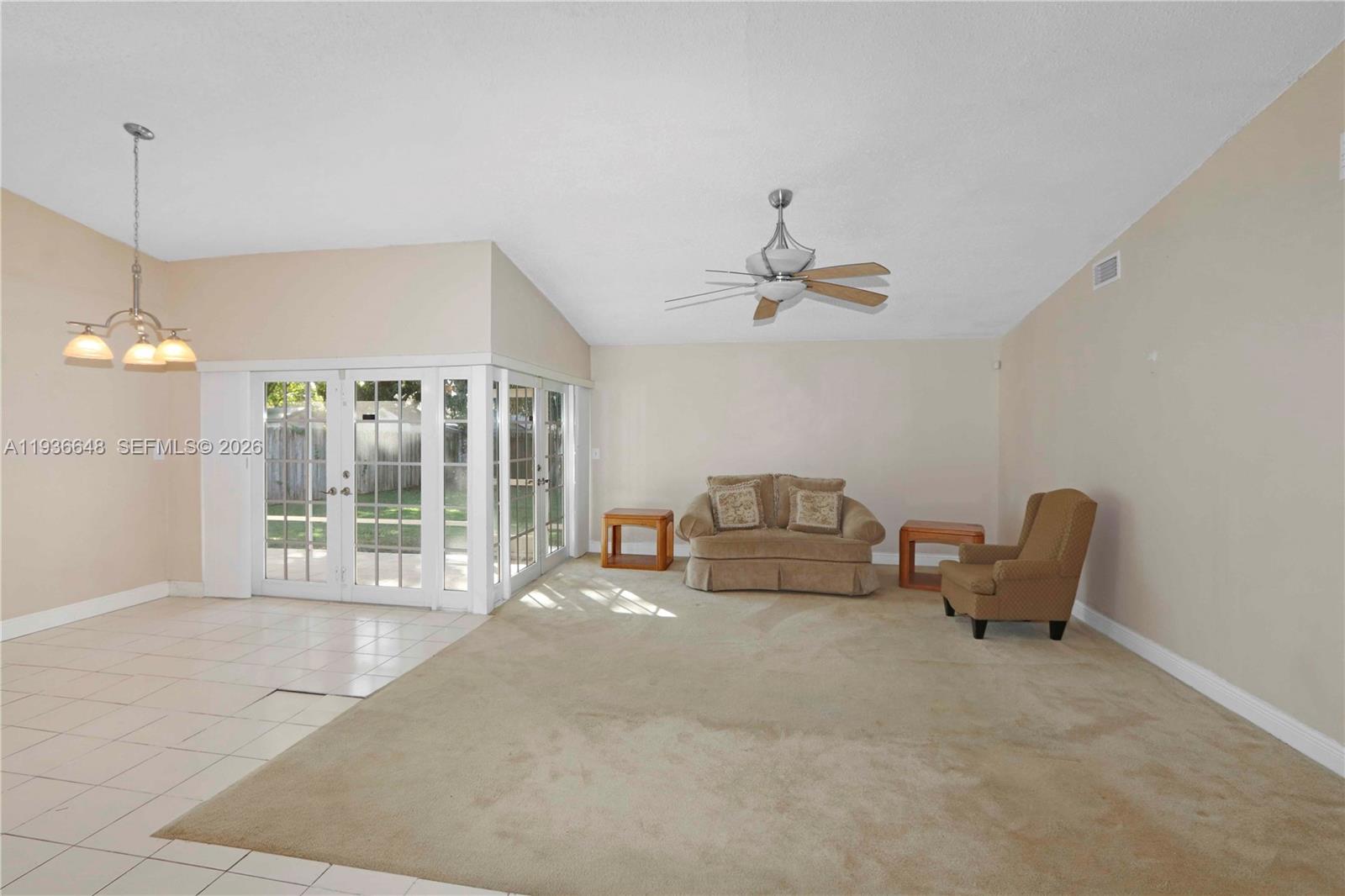 13244 Southwest 255th Terrace Homestead, FL 33032 - Photo 7 of 22 a living room with furniture and chandelier