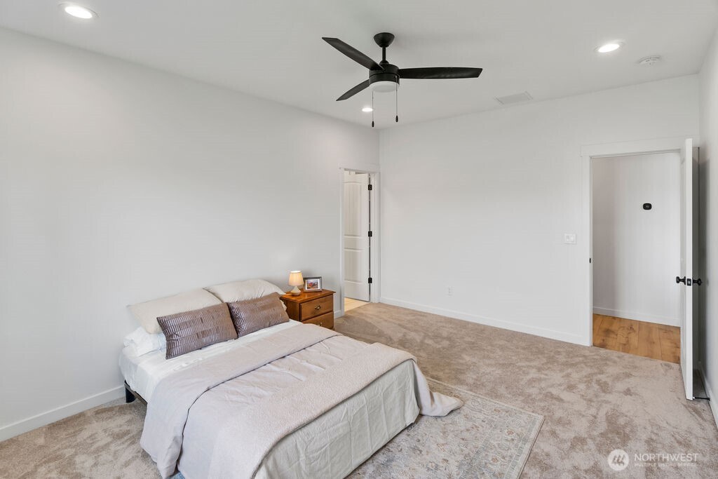 231 Shrute Road Prosser, WA 99350 - Photo 14 of 36 a bedroom with a bed and a ceiling fan
