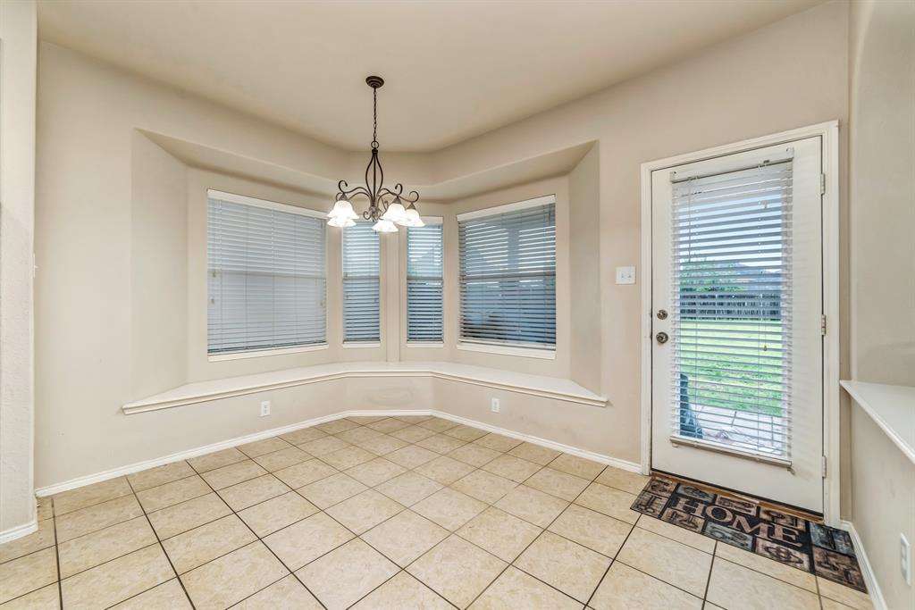 2312 Tawny Owl Road Grand Prairie, TX 75052 - Photo 16 of 40 Unfurnished dining area featuring hanging lights and light tile patterned floors