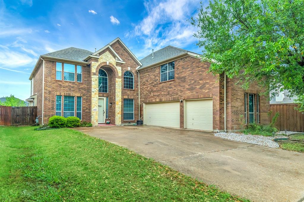 2312 Tawny Owl Road Grand Prairie, TX 75052 - Photo 2 of 40 View of front of property featuring brick siding, an attached garage, and driveway