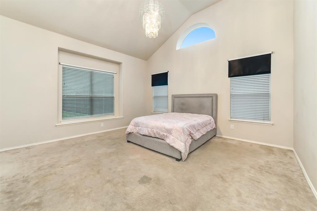 2312 Tawny Owl Road Grand Prairie, TX 75052 - Photo 20 of 40 Bedroom featuring vaulted ceiling, hanging lights, and carpet flooring
