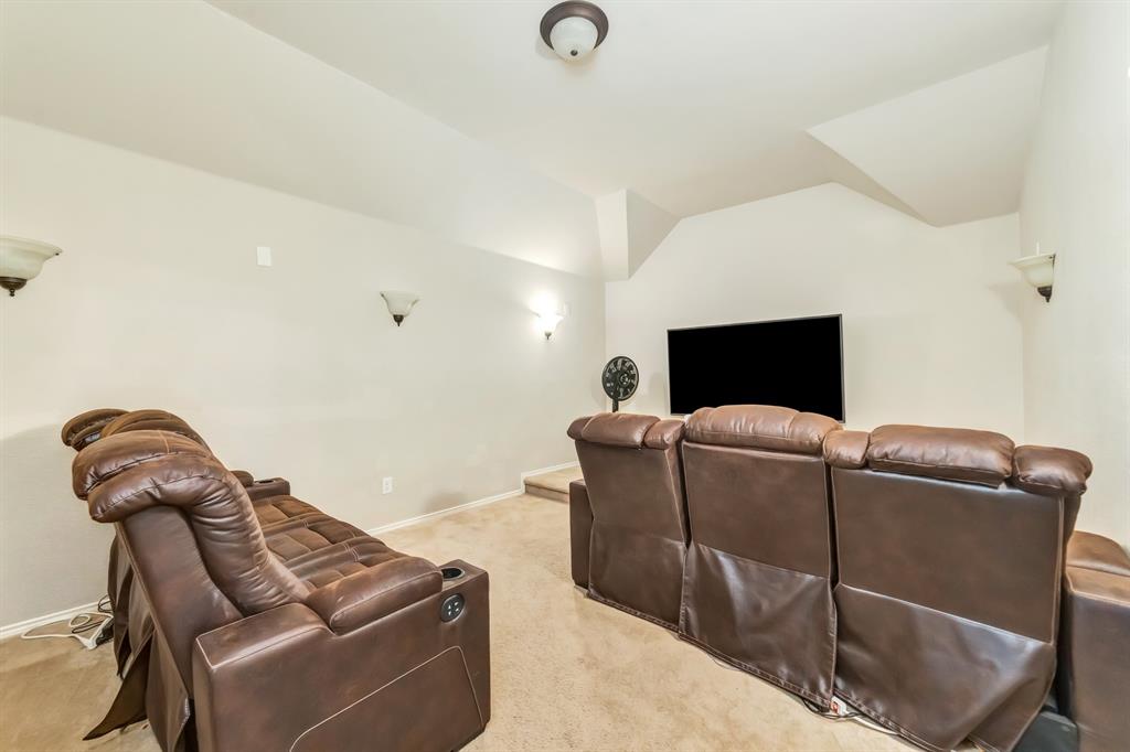 2312 Tawny Owl Road Grand Prairie, TX 75052 - Photo 27 of 40 Home theater with light colored carpet and lofted ceiling