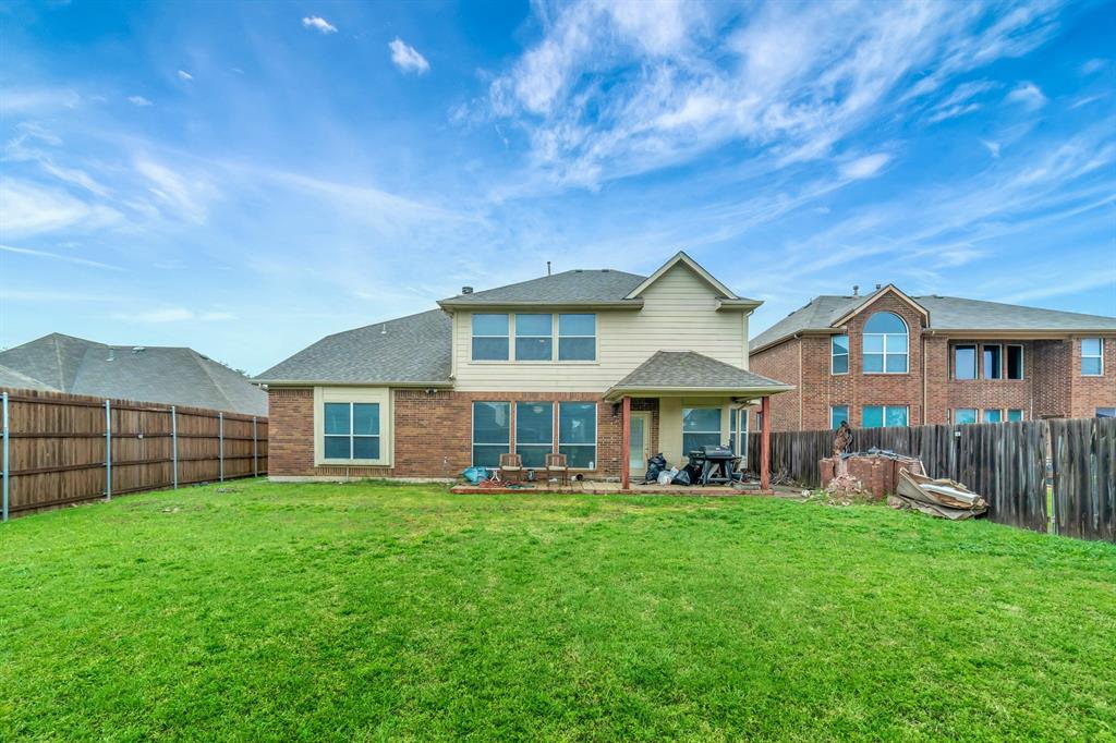 2312 Tawny Owl Road Grand Prairie, TX 75052 - Photo 35 of 40 Rear view of house featuring brick siding, a patio, roof with shingles, and a fenced backyard