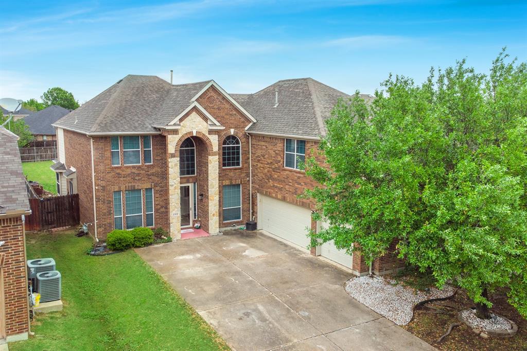 2312 Tawny Owl Road Grand Prairie, TX 75052 - Photo 36 of 40 View of front of house with brick siding, a garage, concrete driveway, and roof with shingles