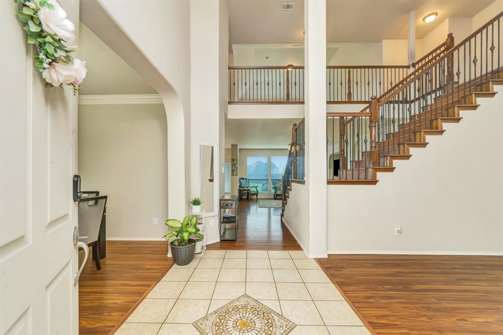 2312 Tawny Owl Road Grand Prairie, TX 75052 - Photo 4 of 40 Entrance foyer featuring light wood-type flooring, a high ceiling, and ornamental molding