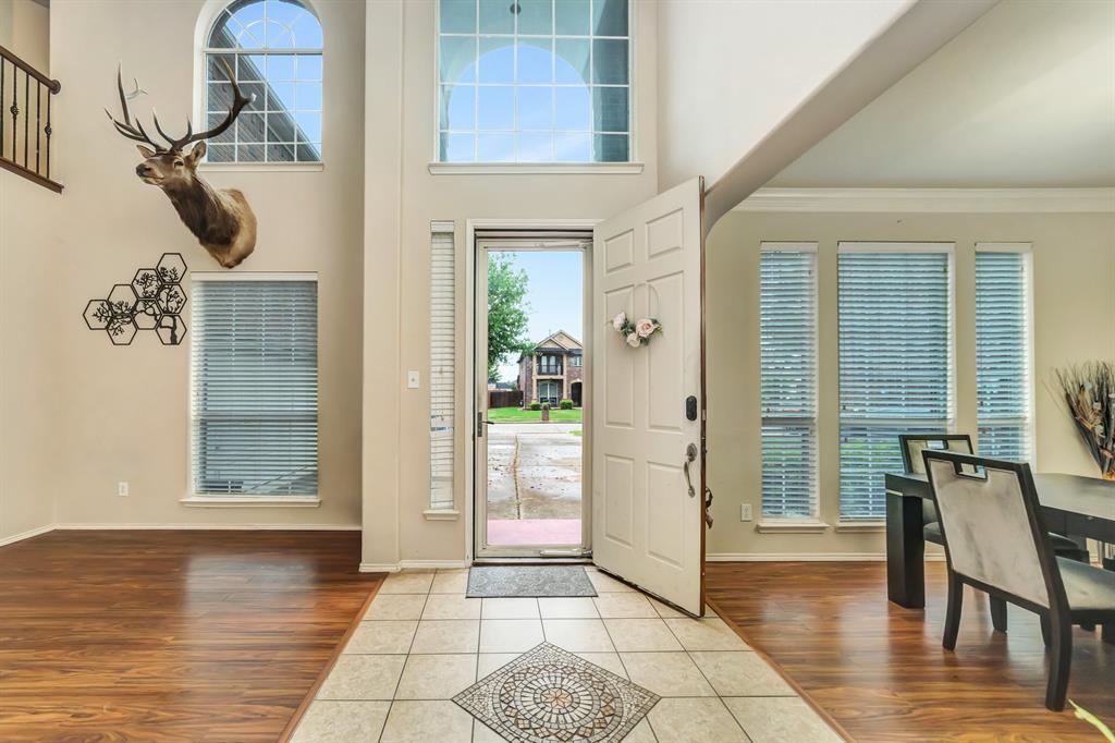 2312 Tawny Owl Road Grand Prairie, TX 75052 - Photo 8 of 40 Entryway with tile patterned floors, a high ceiling, and ornamental molding