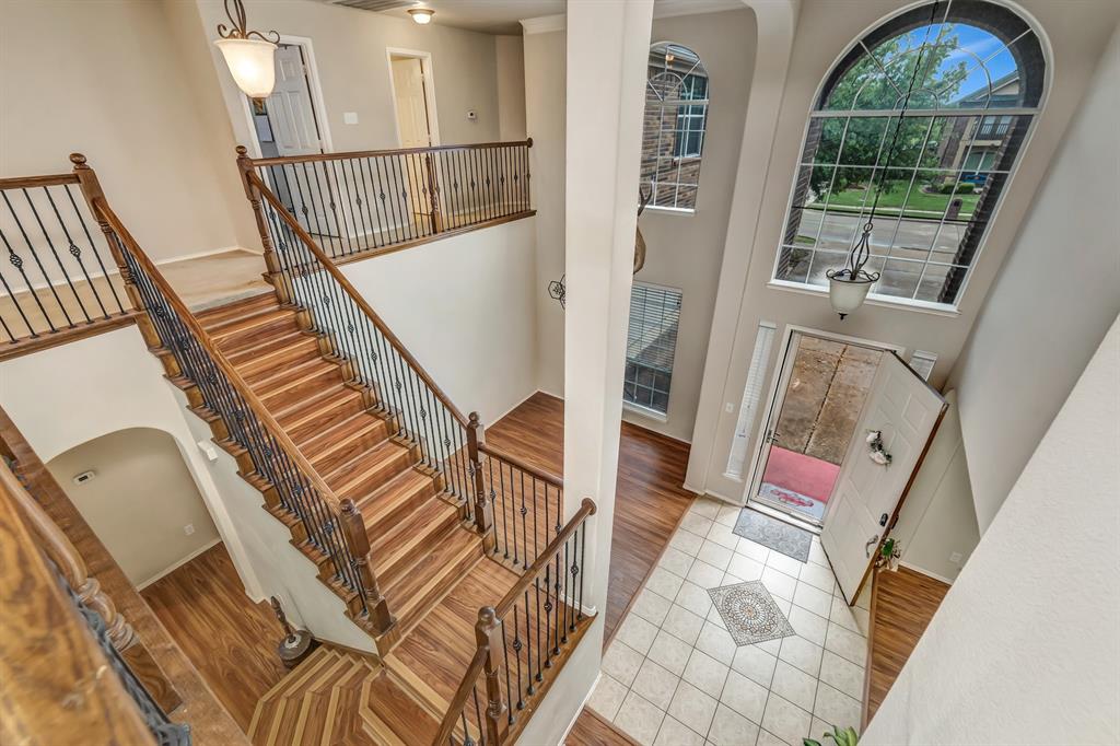 2312 Tawny Owl Road Grand Prairie, TX 75052 - Photo 9 of 40 Entryway with a high ceiling, light wood finished floors, and arched walkways