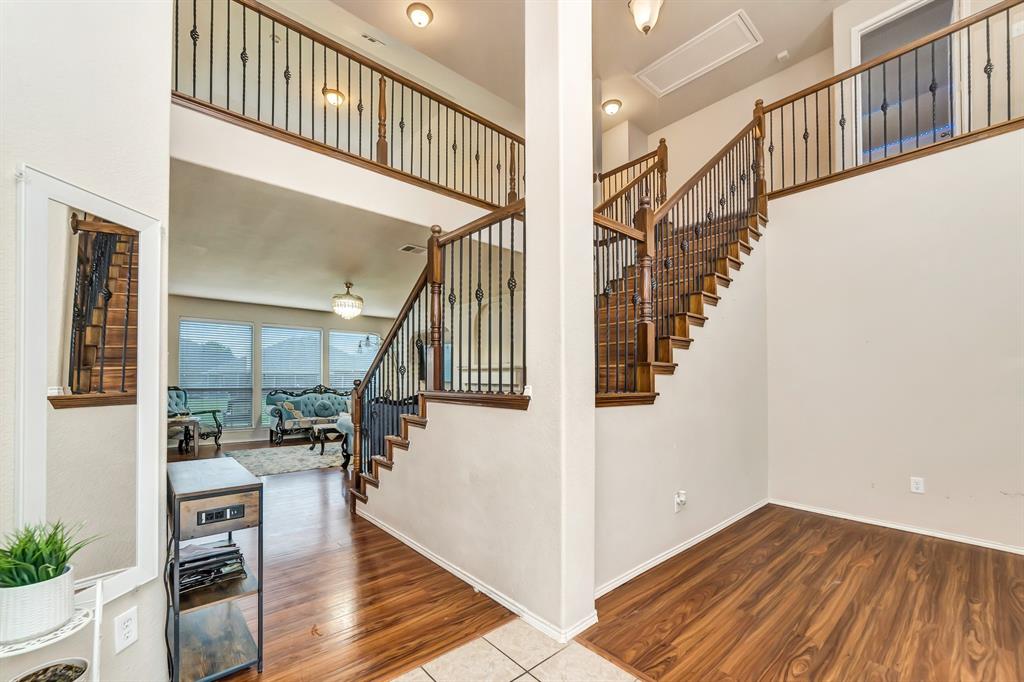 2312 Tawny Owl Road Grand Prairie, TX 75052 - Photo 10 of 40 Stairs with wood finished floors and a high ceiling
