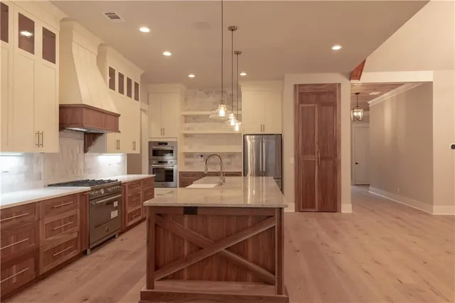 a kitchen with kitchen island granite countertop wooden cabinets and a sink
