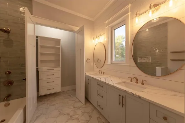 a bathroom with a double vanity sink and a mirror