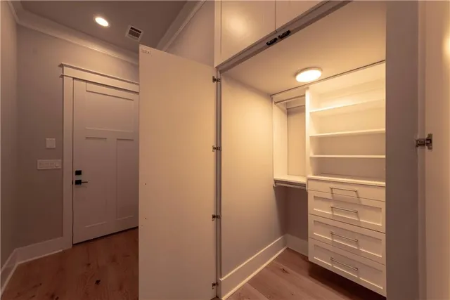 a view of walk in closet with empty racks