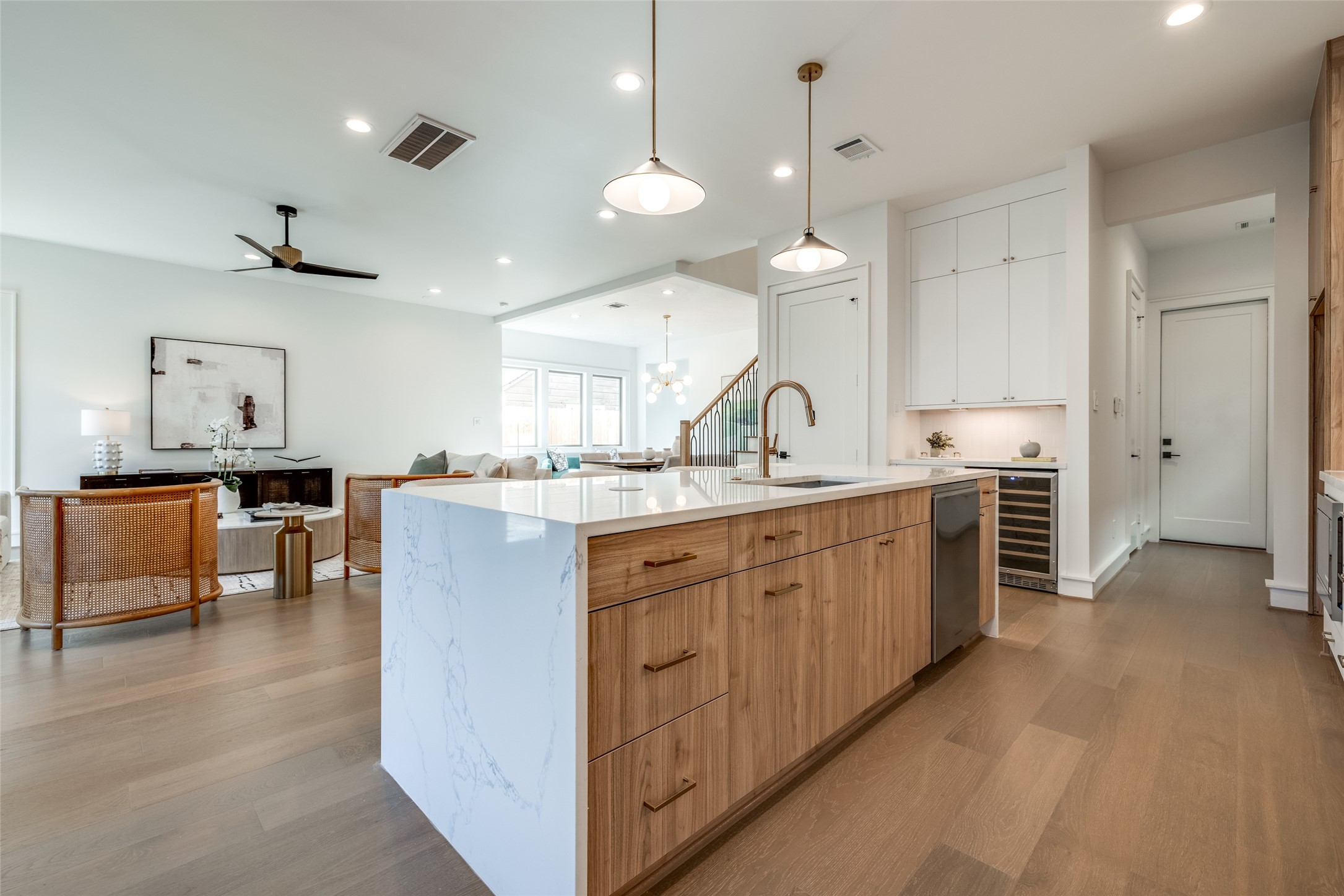 2213 Whitney Street Houston, TX 77006 - Photo 18 of 46 a large kitchen with kitchen island a sink a center island a stove and a chandelier