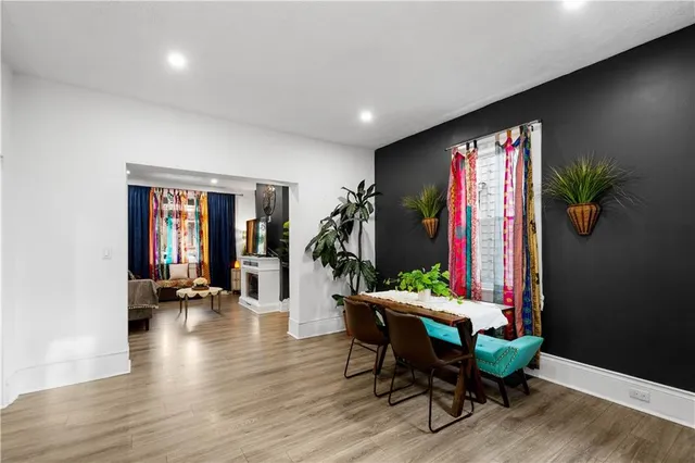 a view of a room with furniture and wooden floor