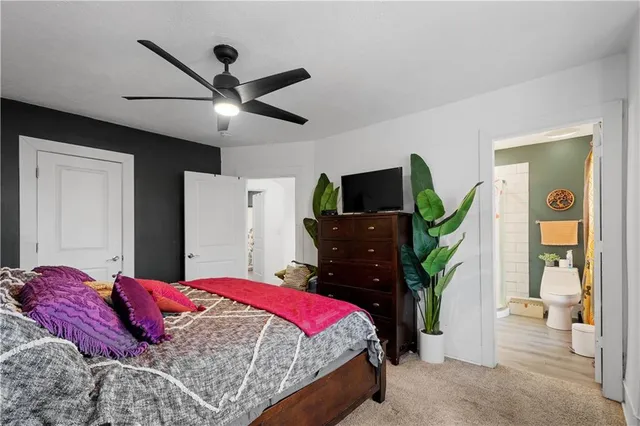 a bedroom with a bed and a flat tv screen