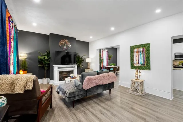 a living room with furniture a fireplace and a flat screen tv