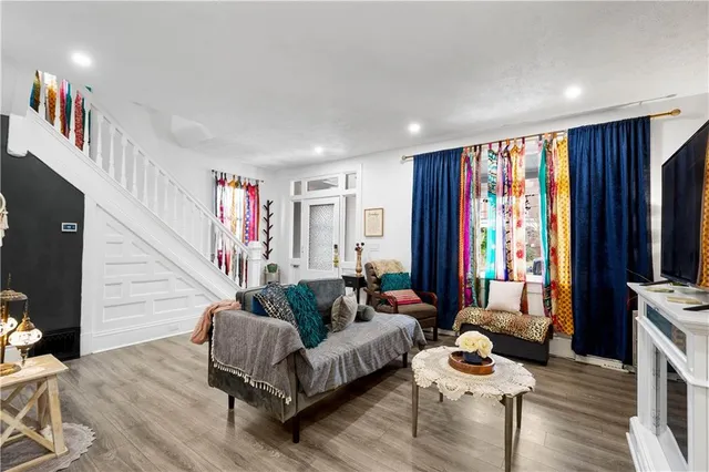 a living room with furniture and a flat screen tv