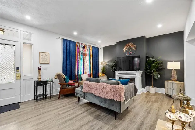 a bedroom with a bed a mirror and a flat tv screen