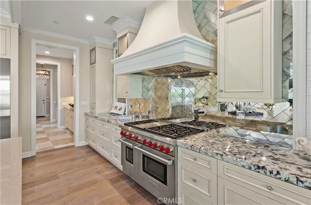 a kitchen with stainless steel appliances granite countertop a stove and a sink
