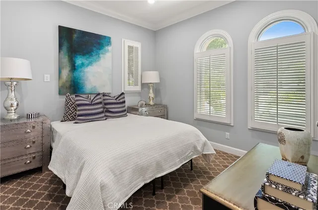 a bedroom with beds and a window