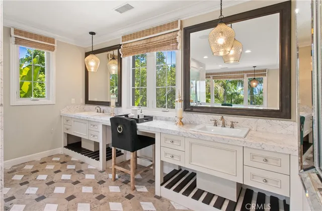a bathroom with a double vanity sink a mirror and a bathtub next to a window