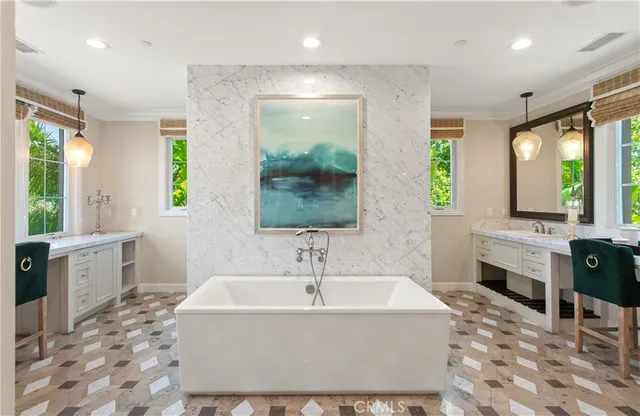 a white bath tub sitting in a bathroom next to a window