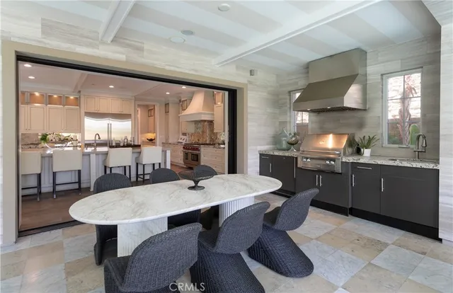 a kitchen with a dining table chairs and white cabinets
