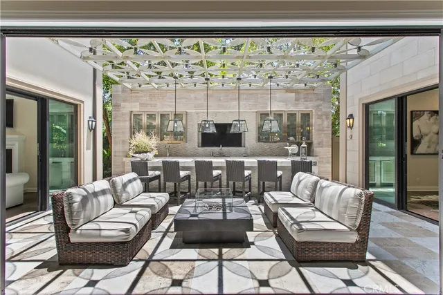 a living room with furniture and a floor to ceiling window