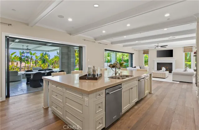 a view of kitchen island a sink and living room view