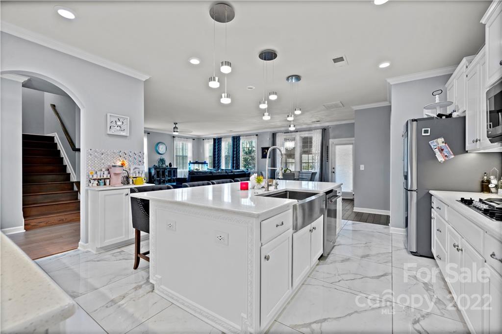 1908 Chatooka Lane Waxhaw, NC 28173 - Photo 15 of 47 a kitchen with stainless steel appliances kitchen island granite countertop a sink and cabinets