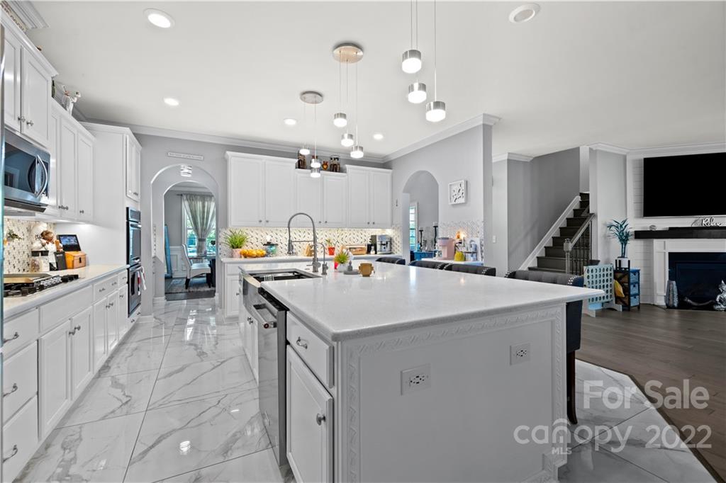 1908 Chatooka Lane Waxhaw, NC 28173 - Photo 16 of 47 a large white kitchen with lots of counter space and breakfast area