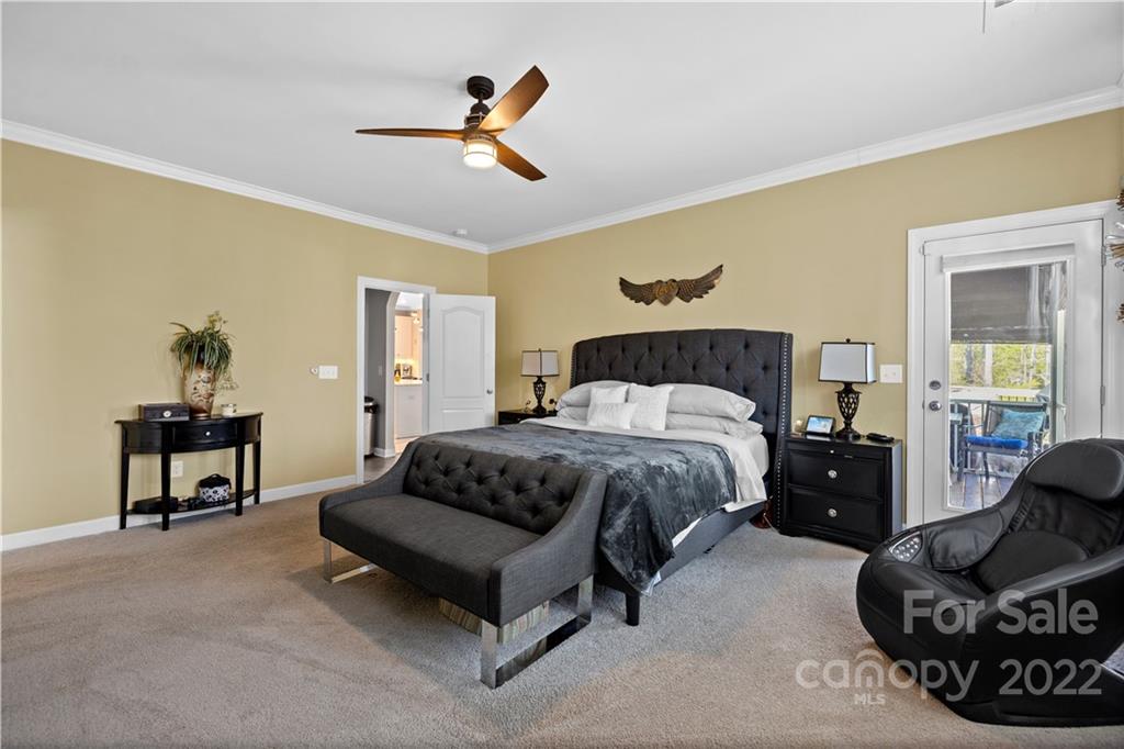 1908 Chatooka Lane Waxhaw, NC 28173 - Photo 24 of 47 a spacious bedroom with a bed a couch and a dresser
