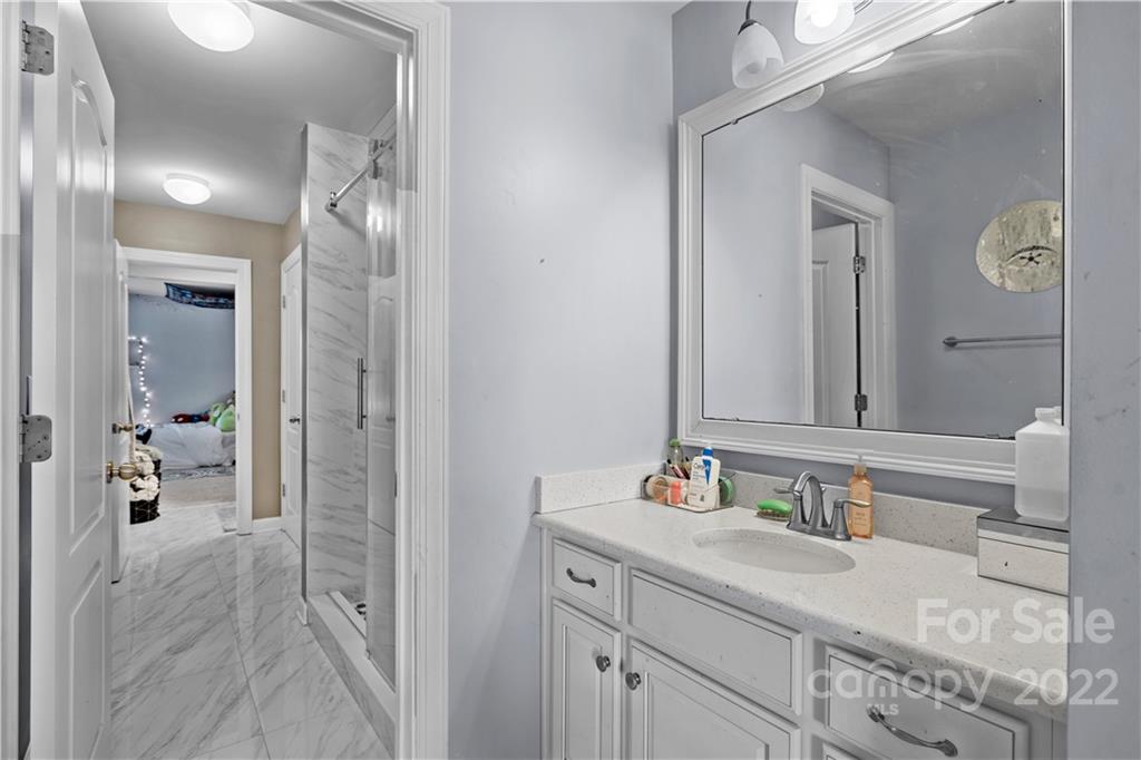 1908 Chatooka Lane Waxhaw, NC 28173 - Photo 35 of 47 a en suite bathroom with a granite countertop sink and a mirror