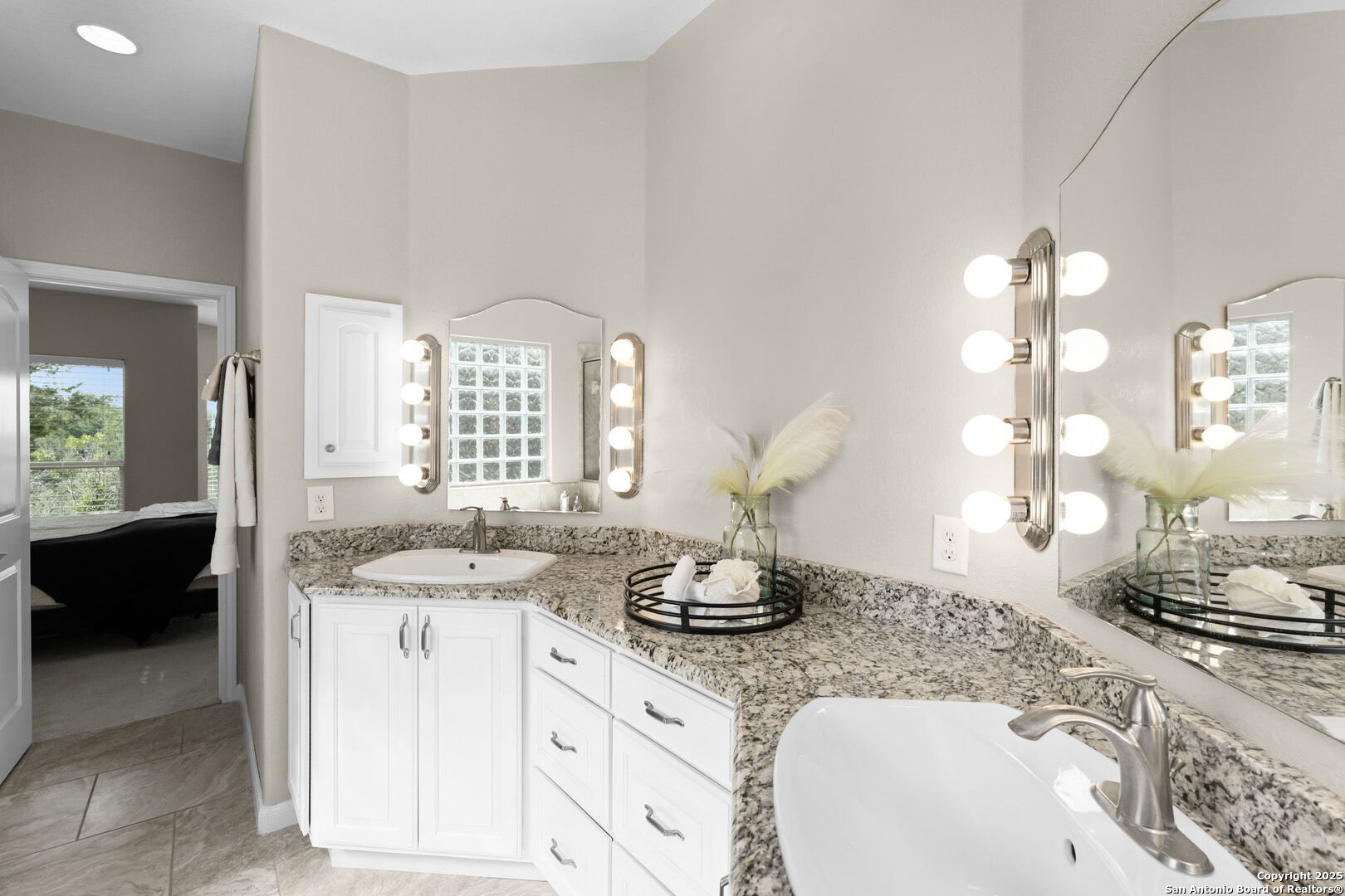 171 Clear Ridge New Braunfels, TX 78132 - Photo 23 of 41 a bathroom with a granite countertop sink a large mirror and a window