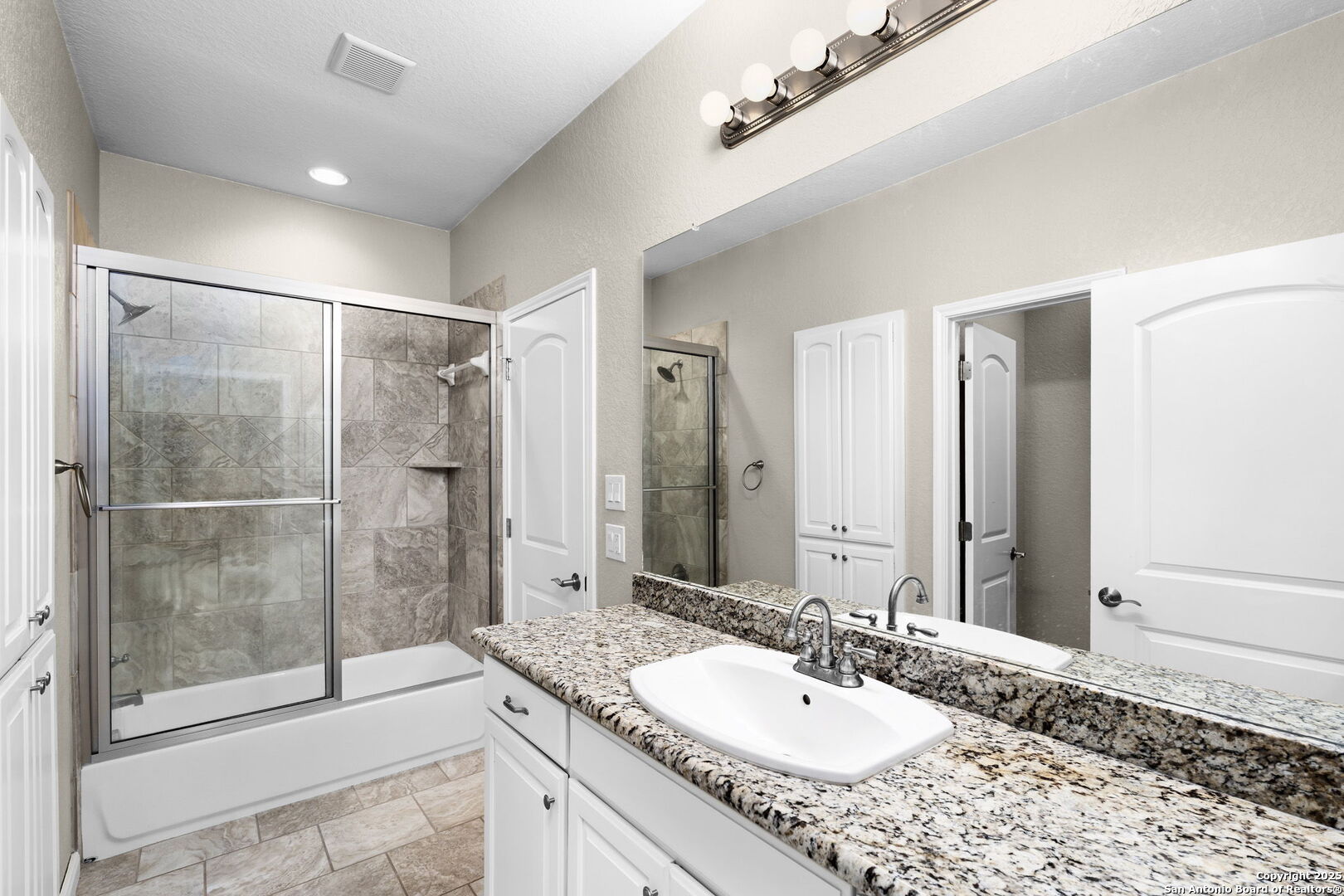 171 Clear Ridge New Braunfels, TX 78132 - Photo 32 of 41 a bathroom with a granite countertop sink mirror and shower