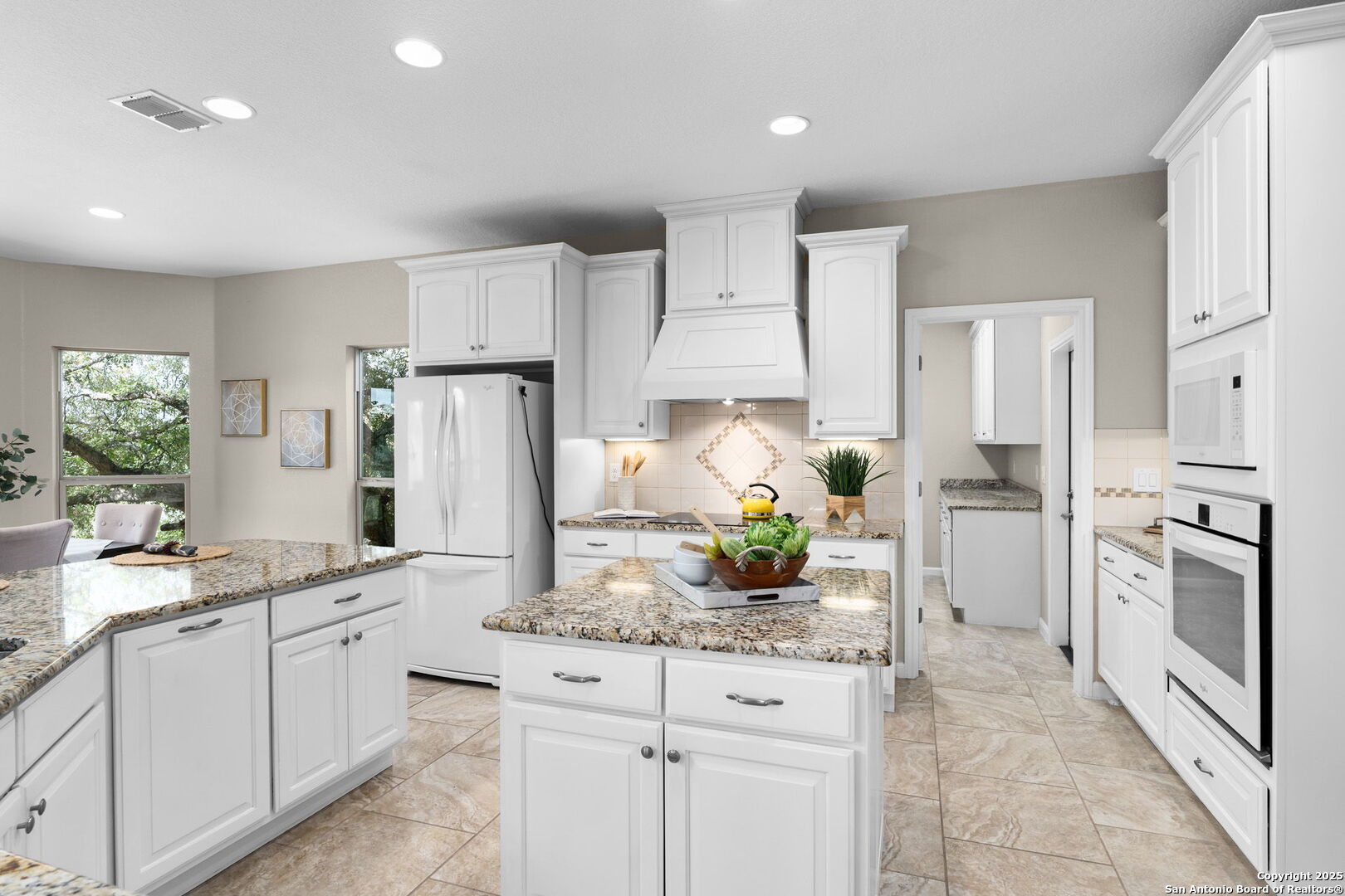 171 Clear Ridge New Braunfels, TX 78132 - Photo 10 of 41 a kitchen with white cabinets and stainless steel appliances