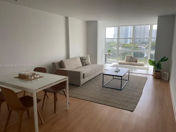 a living room with furniture and a table with wooden floor