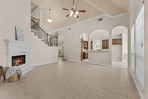 a living room with furniture fireplace and window