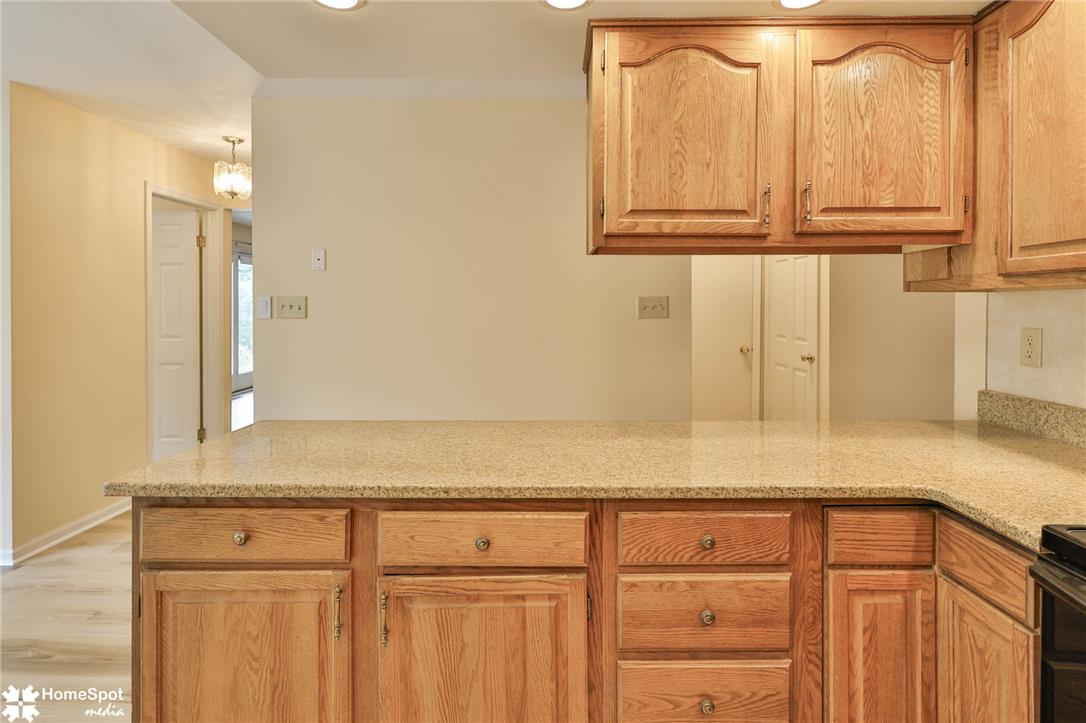 4059 Wedgewood Road Allentown, PA 18104 - Photo 18 of 72 Golden wood cabinetry with ample storage complements the polished granite countertops.