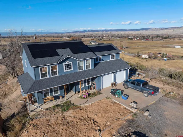 an aerial view of a house with a ocean view